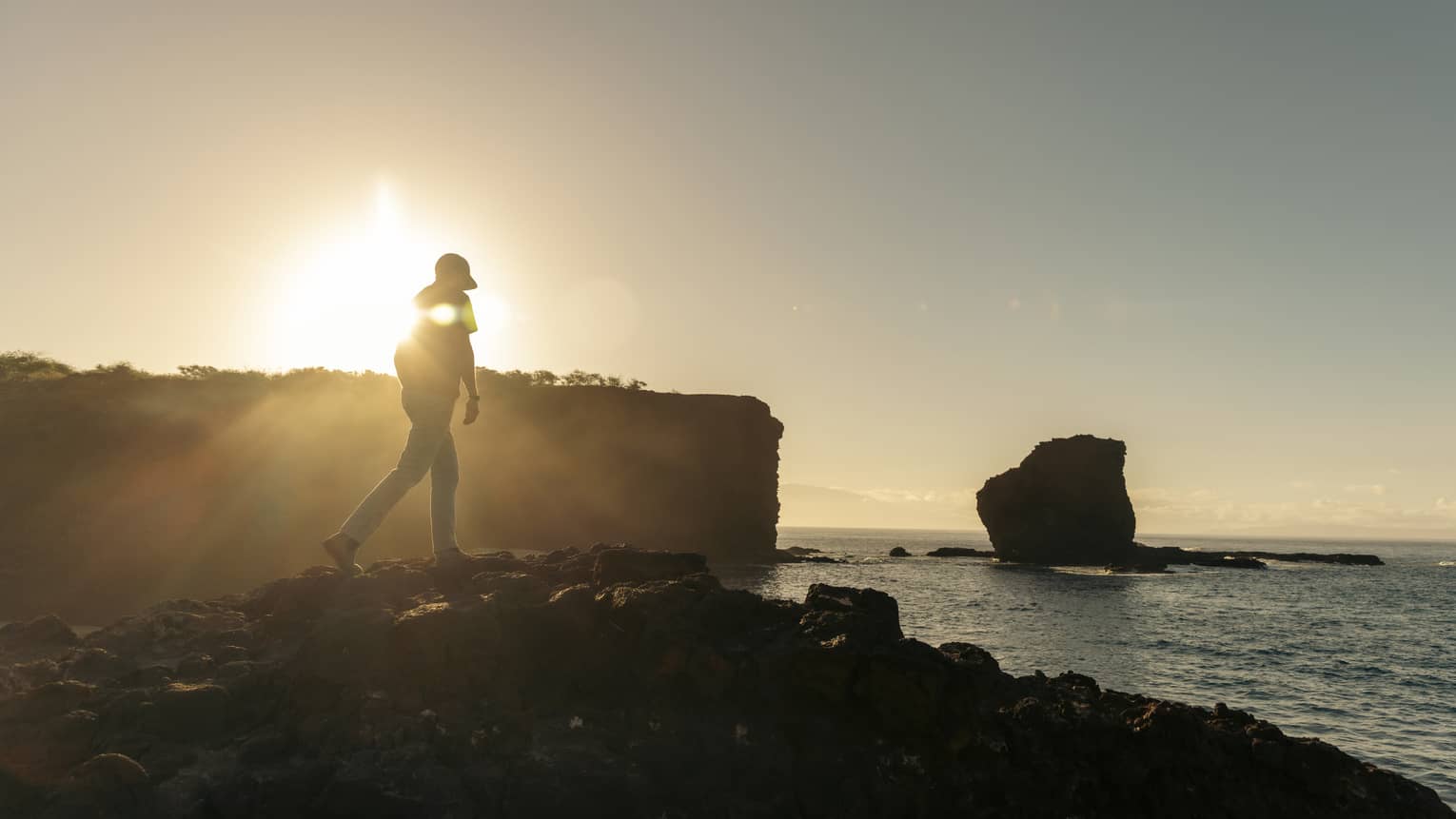 Man walks toward PuuPehee Rock in Lanai, Hawaii