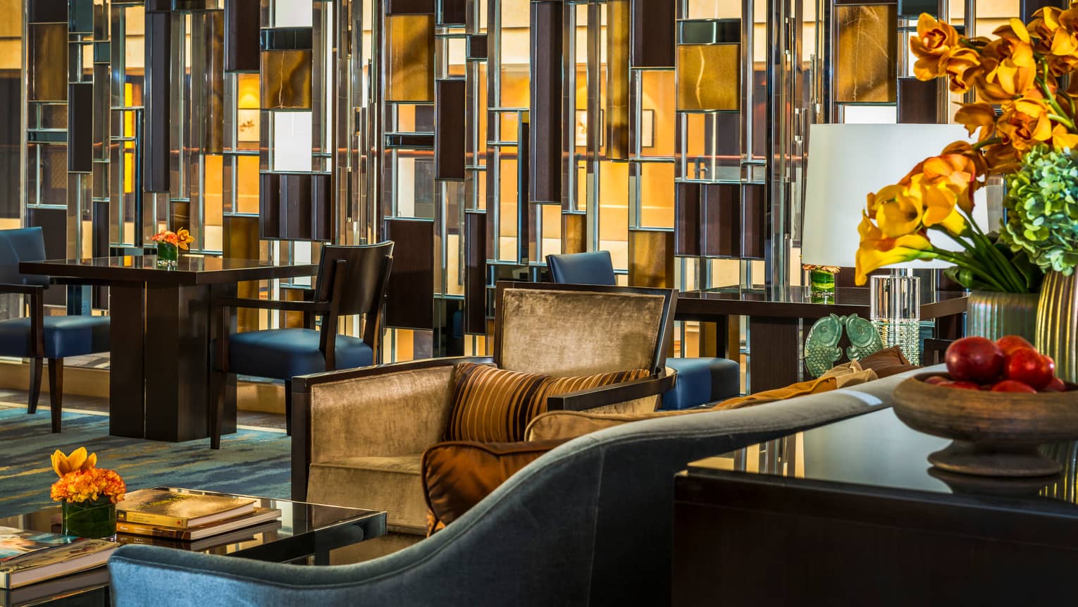 Close-up of Executive Club Lounge armchairs, decorative glass accent wall with wood panels
