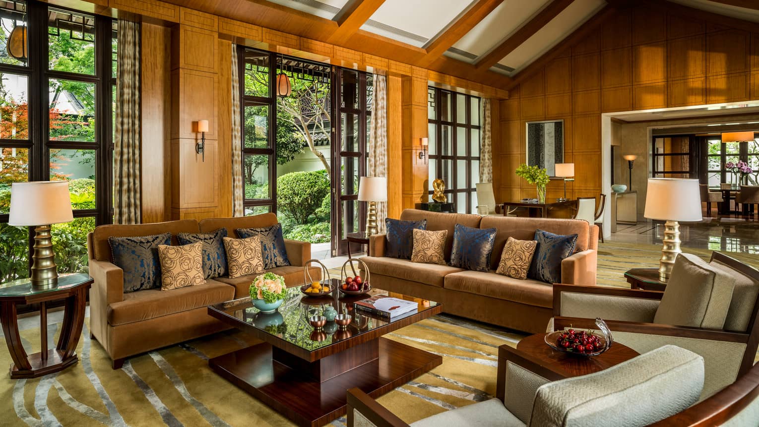 Presidential Villa with two orange velvet sofas, chairs around modern wood table