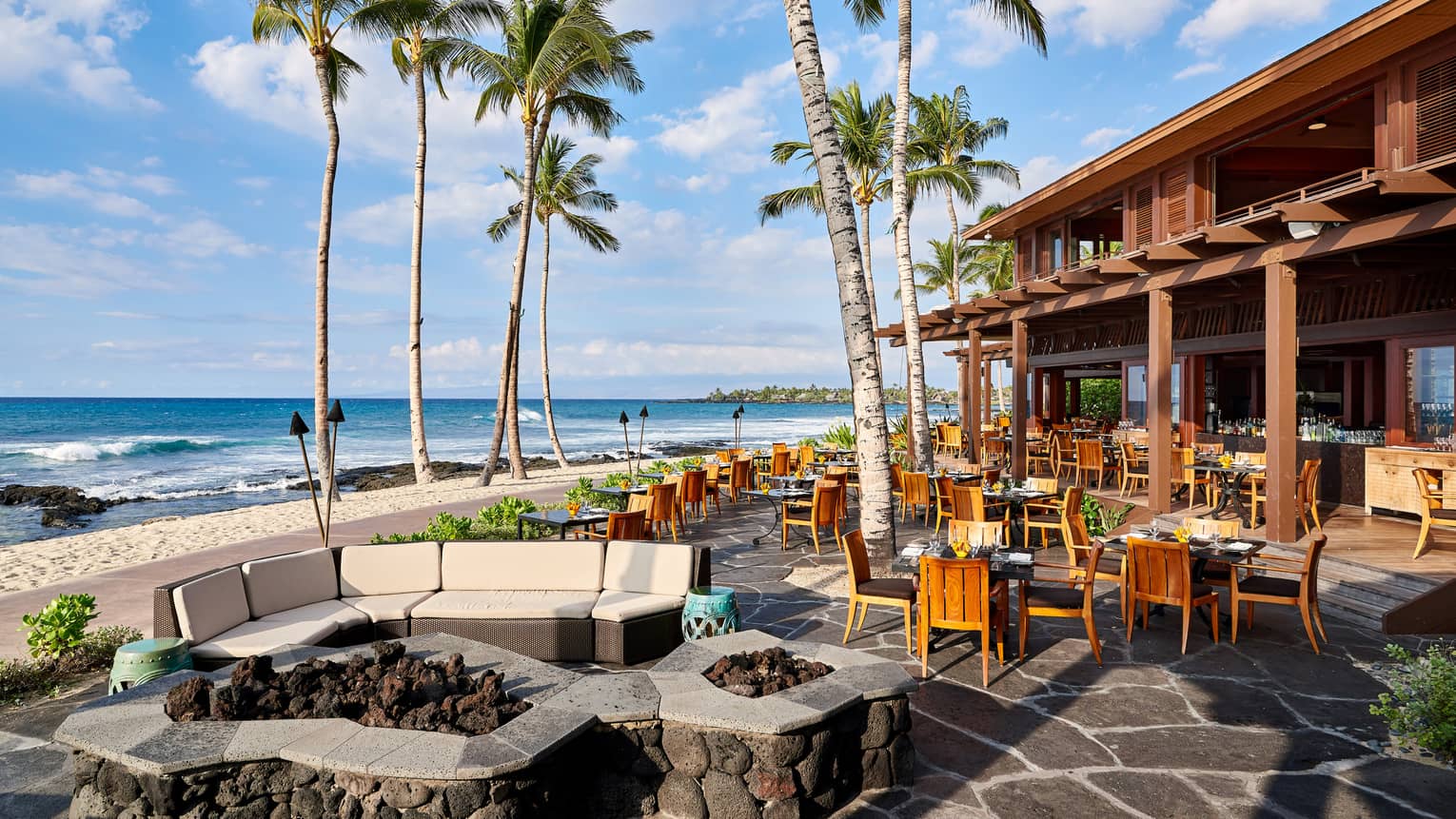 ULU Ocean Grill sunny patio dining room under palm trees, near beach 
