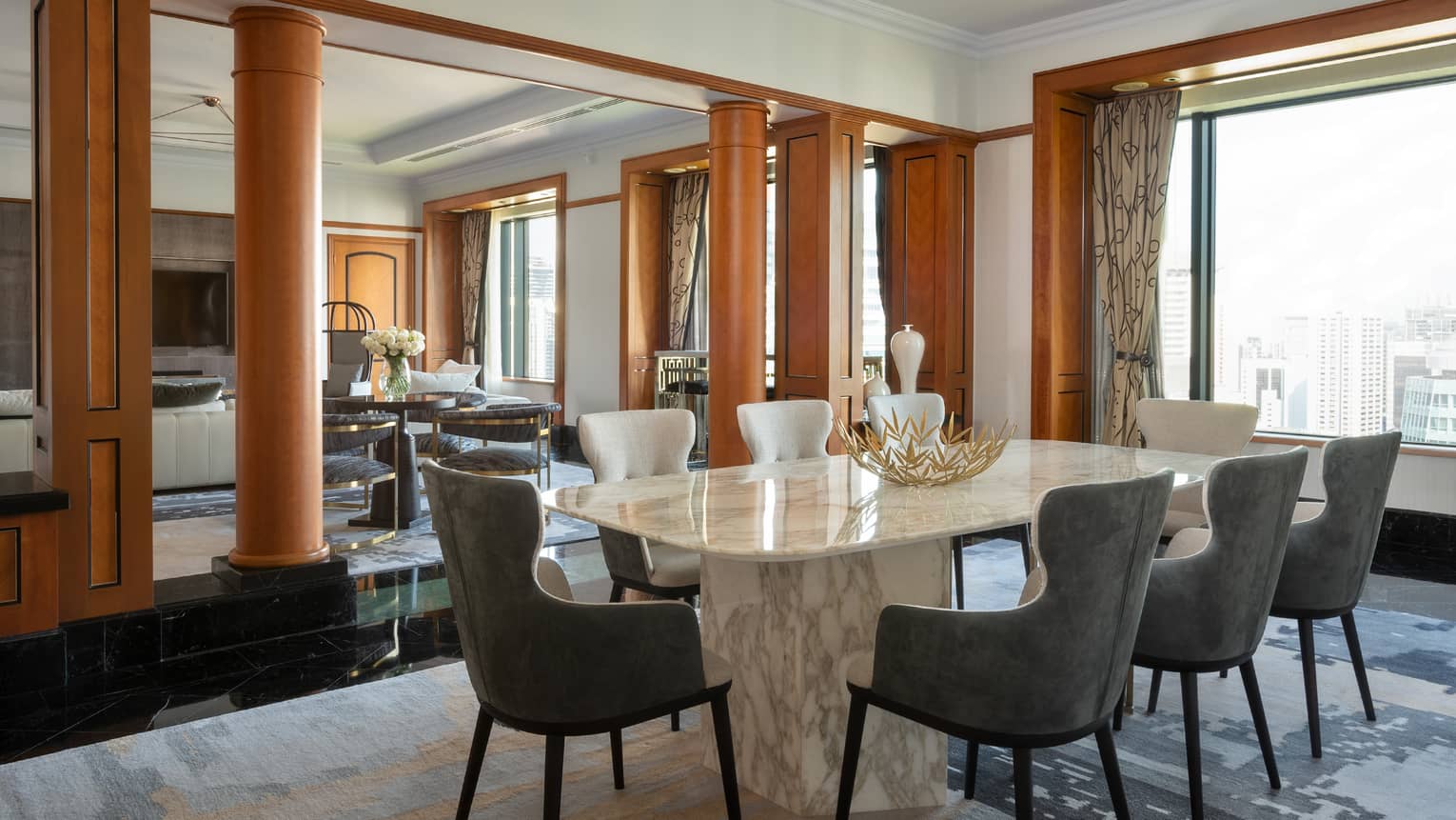 Presidential suite dining area with marble table and floor-to-ceiling windows