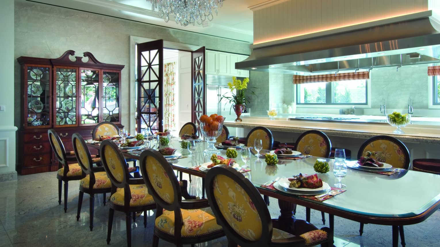 Wooden dining table, upholstered yellow patterned dining chairs by kitchen, wooden display cabinet