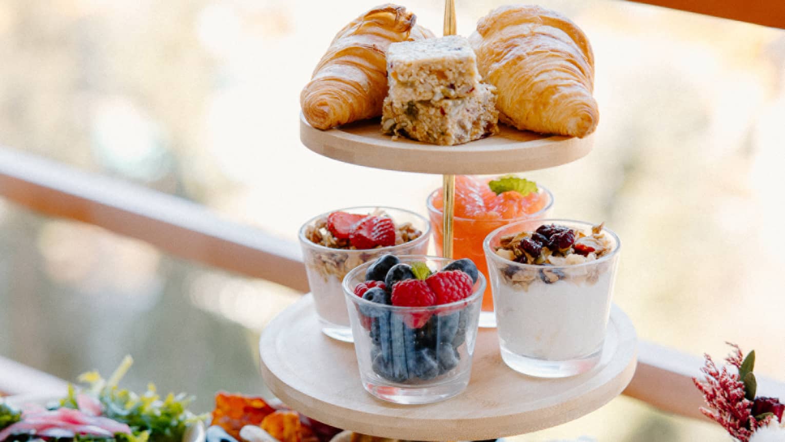 Three-tier tower with breakfast spread on outdoor table