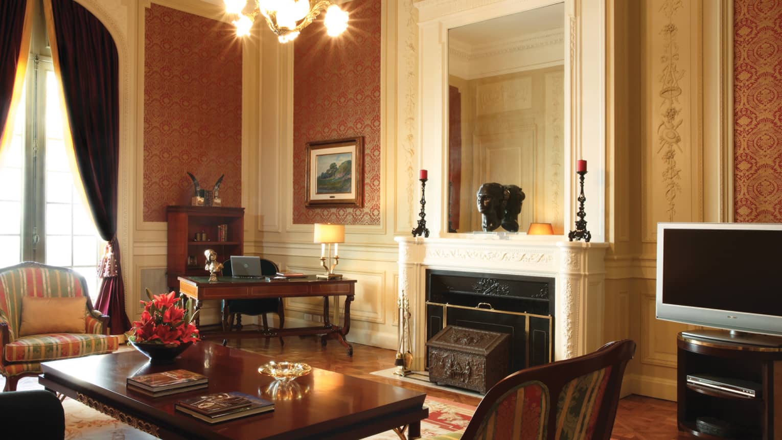 La Mansión Royale Suite living room with white fireplace mantel, dark wood furniture, Old World decor