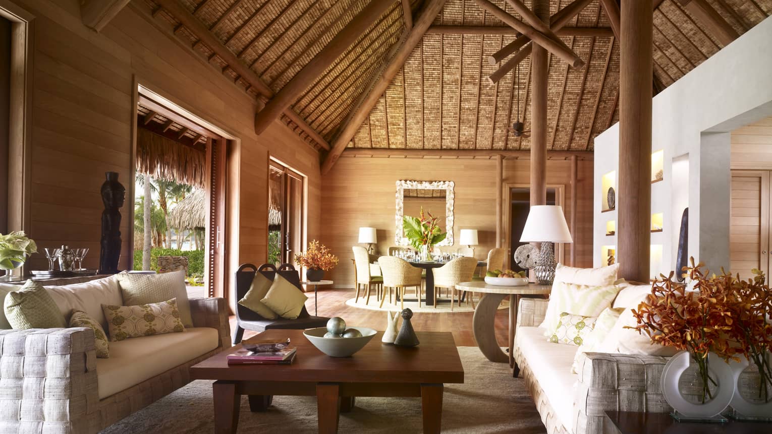 Large, bright bungalow with thatched cathedral ceiling, white sofas, Polynesian art 