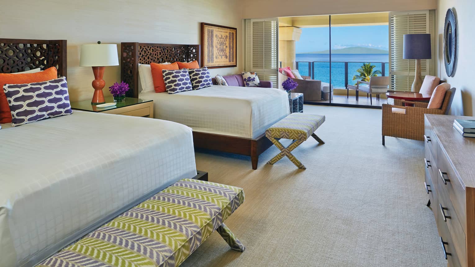 Maile Suite double bedroom with view onto the ocean and colourful bedding