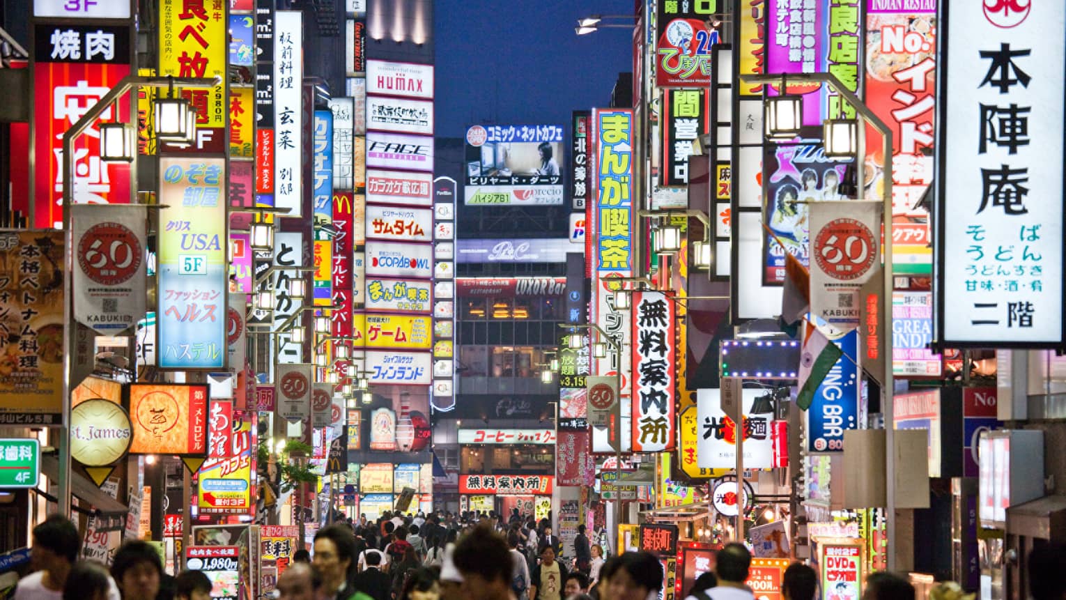 Crowds under Tokyo lights, colourful billboards