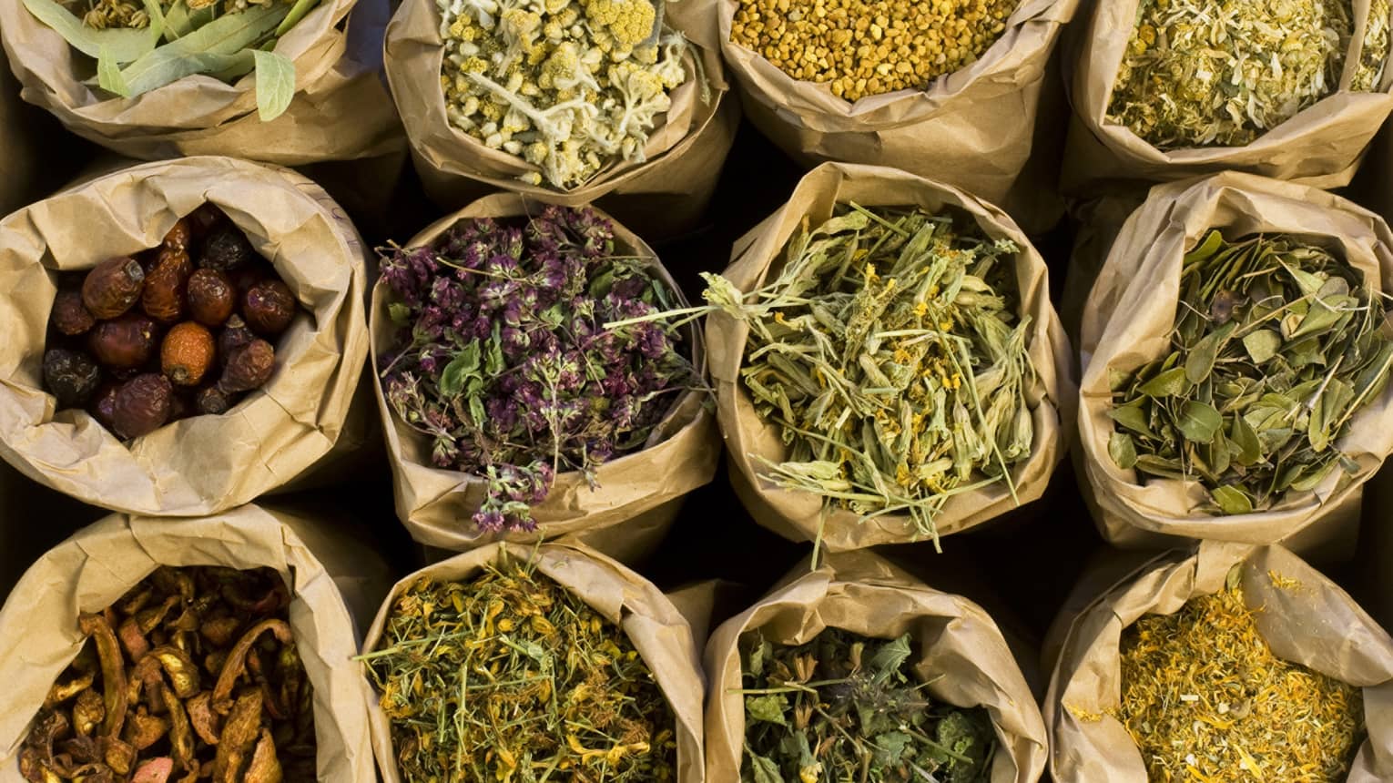 Bags are full of herbs, dried flowers, peppers and spices