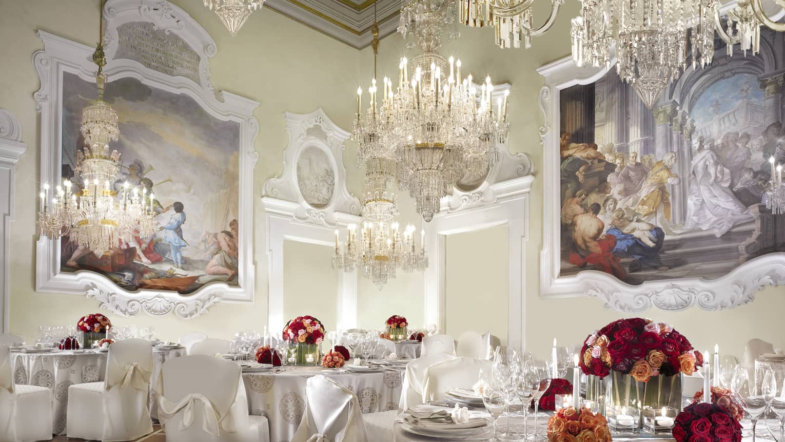 Gherardesca ballroom with large crystal chandeliers, paintings over elegant banquet tables 