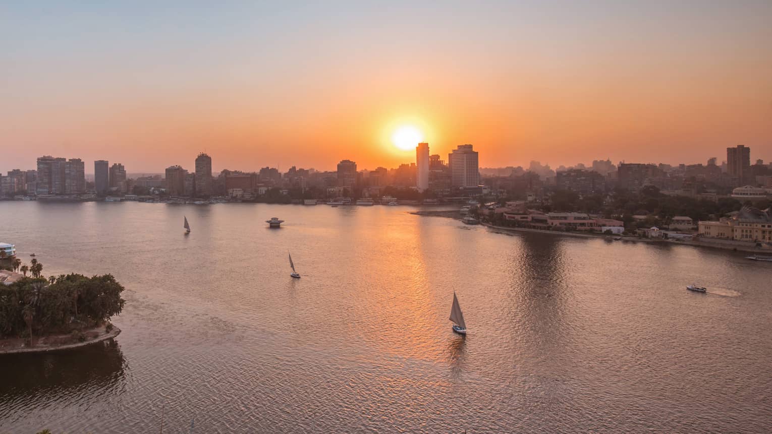 Sunset over Nile River with sailboats in Cairo, Egypt