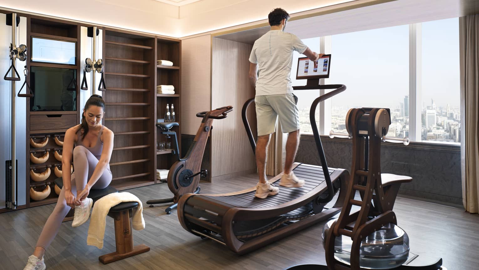 Man and woman work out in their en-suite fitness room