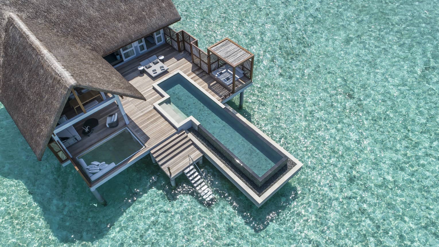 Aerial view of lure island villa with private pool and deck surrounded by crystal ocean