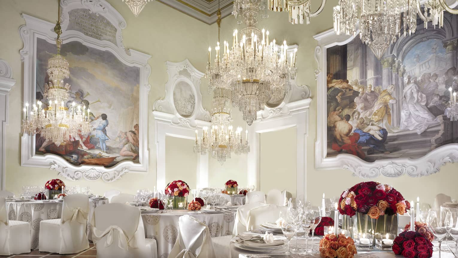 Gherardesca ballroom with large crystal chandeliers, paintings over elegant banquet tables 
