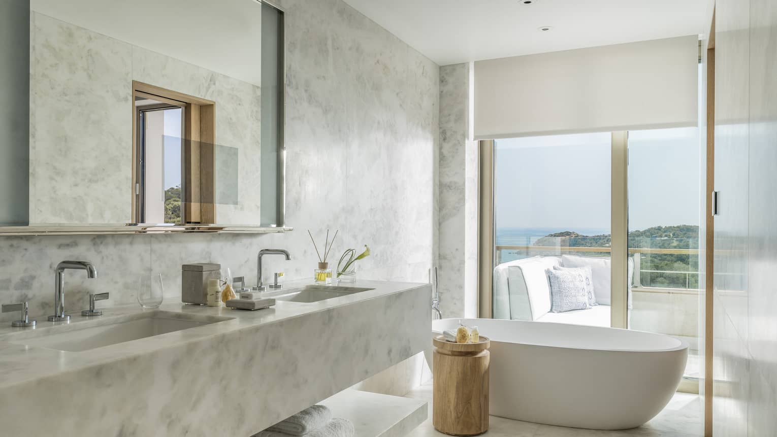 Arion Pine View Bathroom with marbled double vanity, full-width mirror, large soaking tub, ocean views