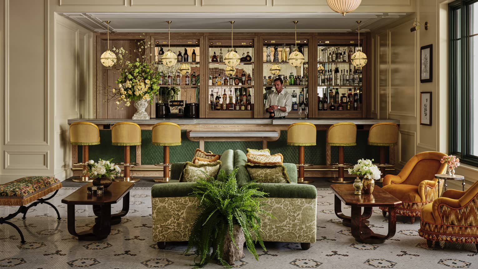 A bar area with colourful seats and plants.