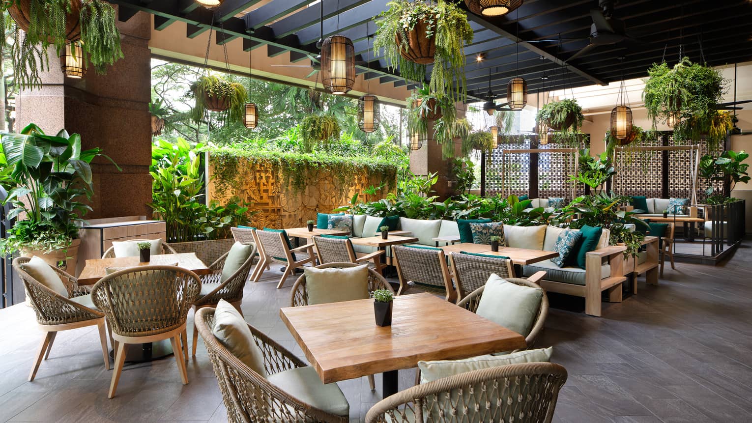 Garden@One-Ninety outdoor lounge with rattan chairs, square tables for four, portico ceiling, hanging plants and lighting