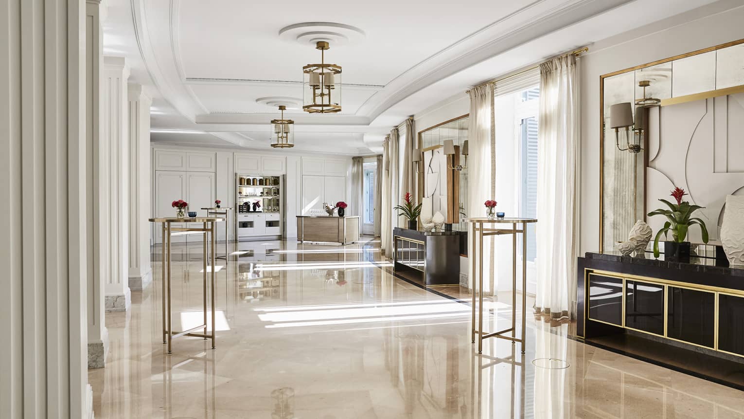 Spacious salon, marble floors, hanging chandeliers, windows