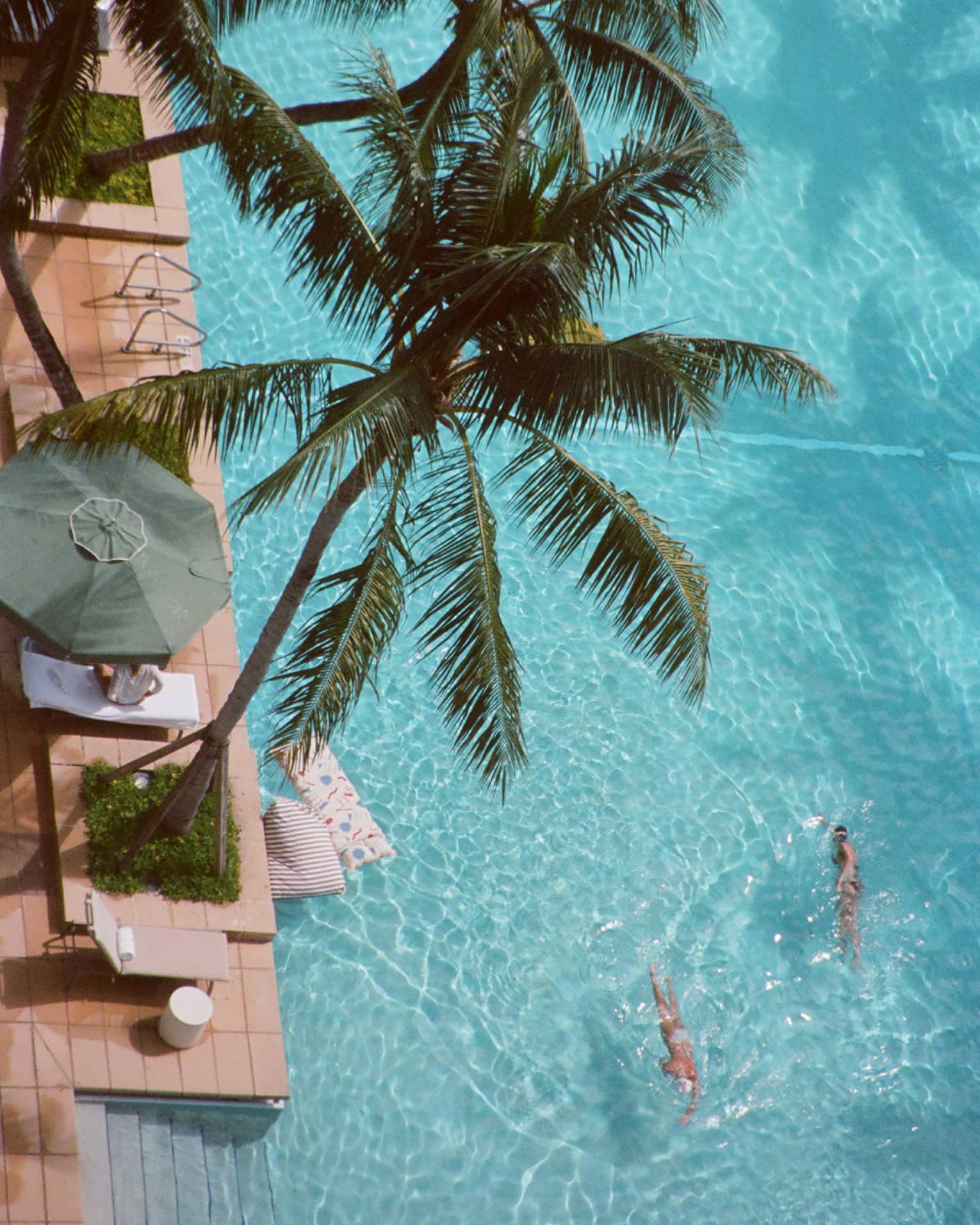 Aerial view of resort pool with palm trees