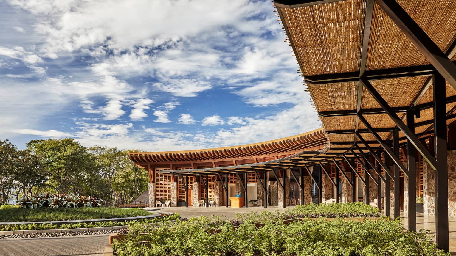 Curved rattan roof, pillars over Four Seasons Hotel Costa Rica at Peninsula Papagayo front entrance