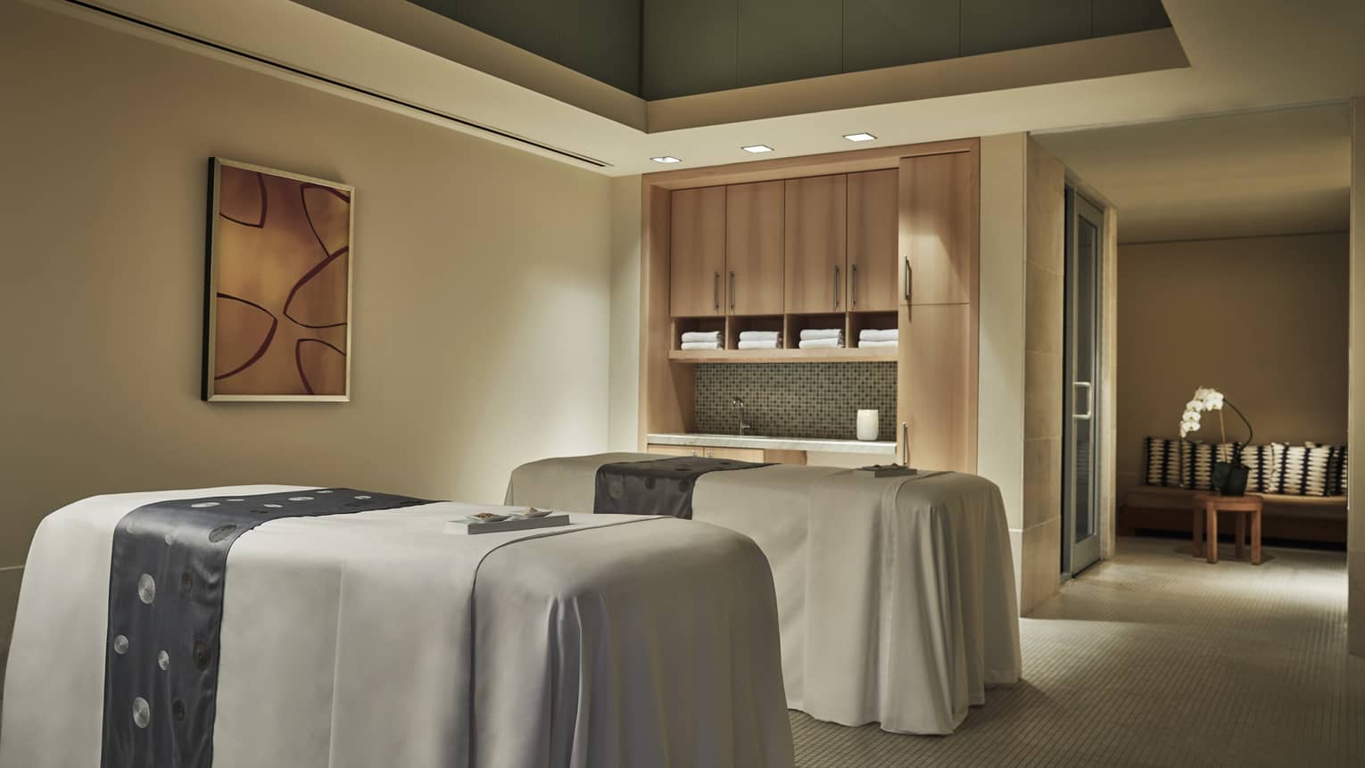 Two massage tables in spa couples treatment room