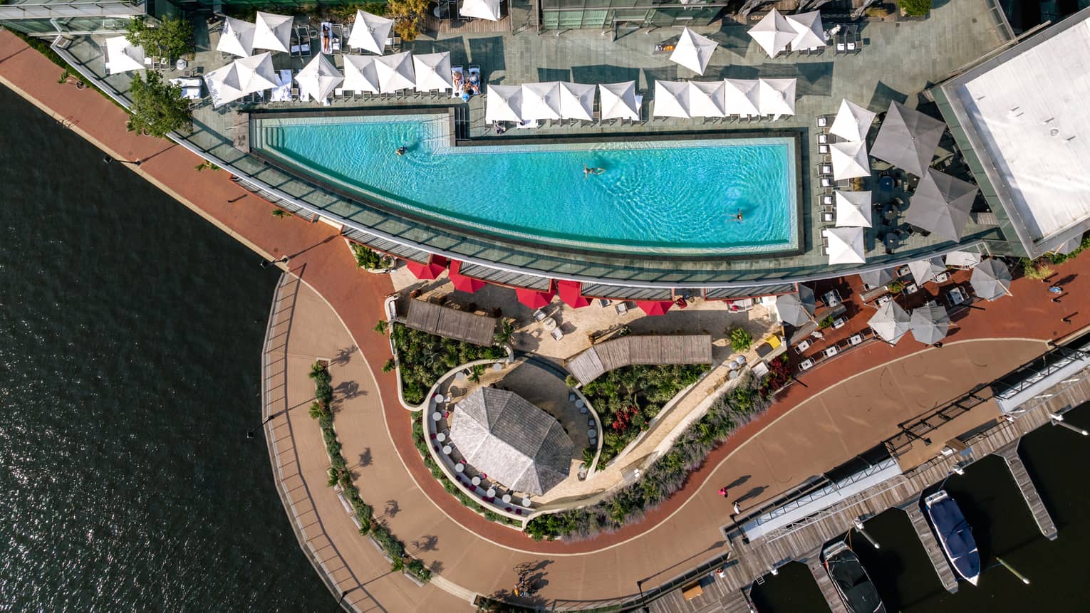 Aerial view of a rooftop pool with cabanas.