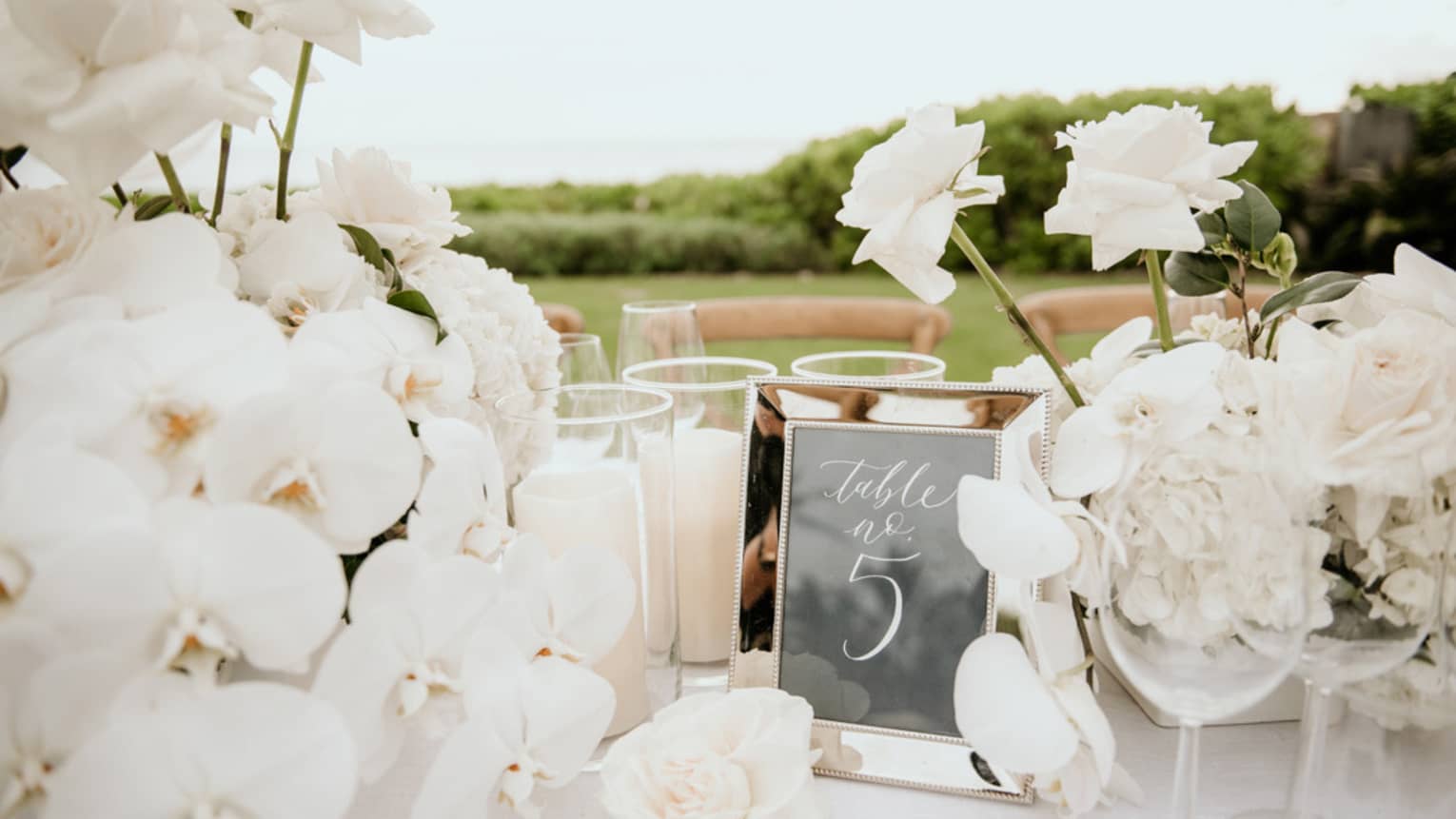 Wedding table setting with white orchid centrepieces