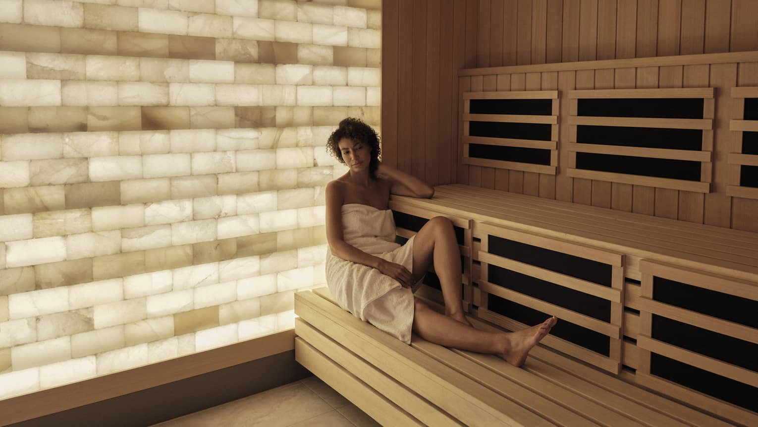 Woman relaxes in the salt-wall sauna