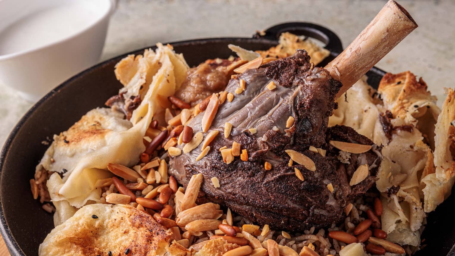 Lamb and rice in a black pot.