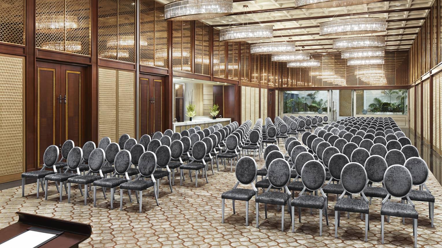 Rows of meeting chairs facing podium in long Gallery ballroom
