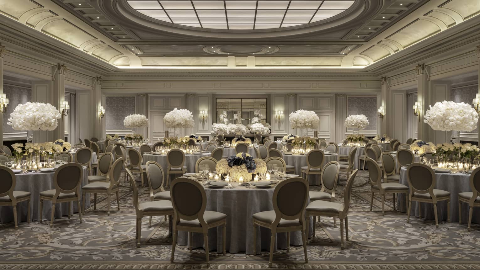 Elegant Paris banquet room, dining tables with white floral centrepieces under decorative domed ceiling