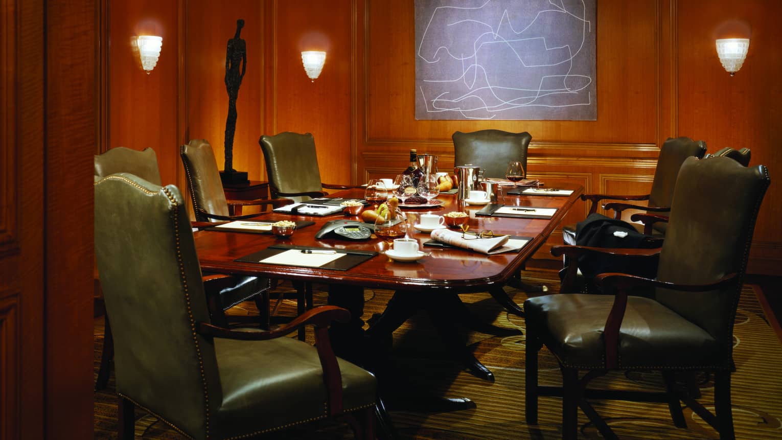 Large boardroom meeting table in room with wood panel walls