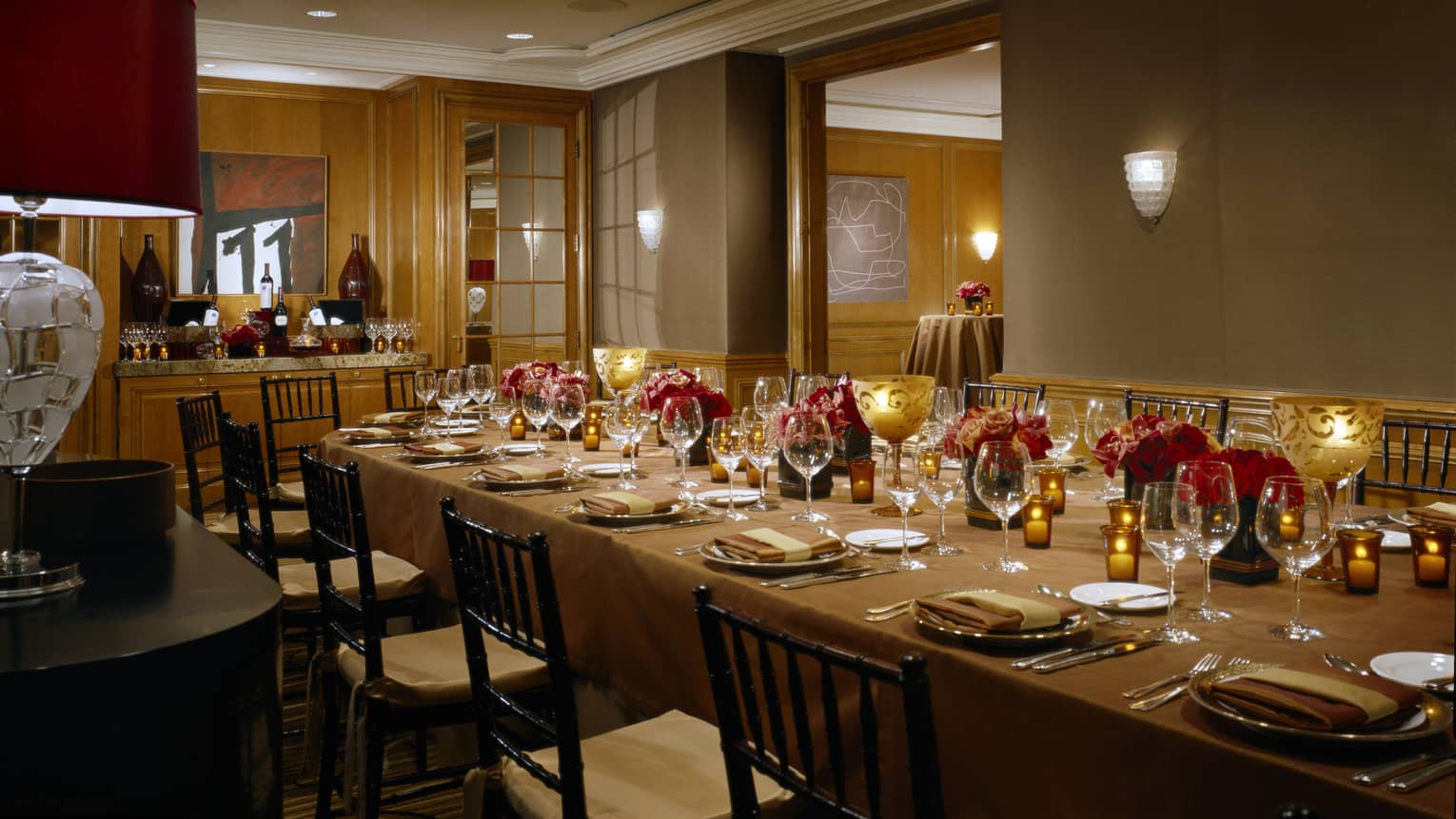 Long private dining table with glowing candles in La Fiesta Room