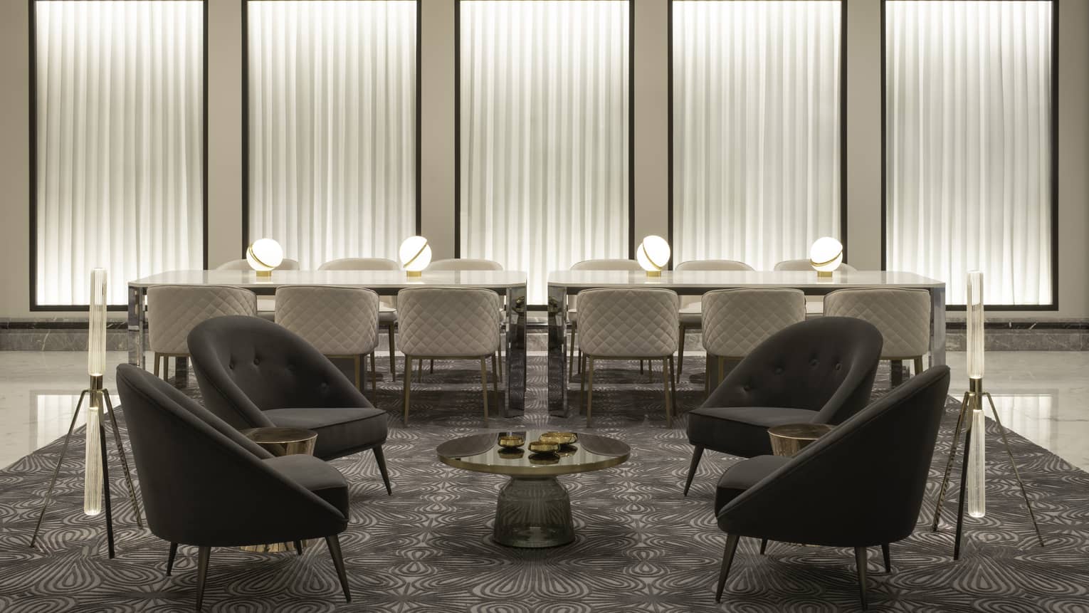 Another sitting area in the lounge, featuring a casual area and two tables that can seat six people each.