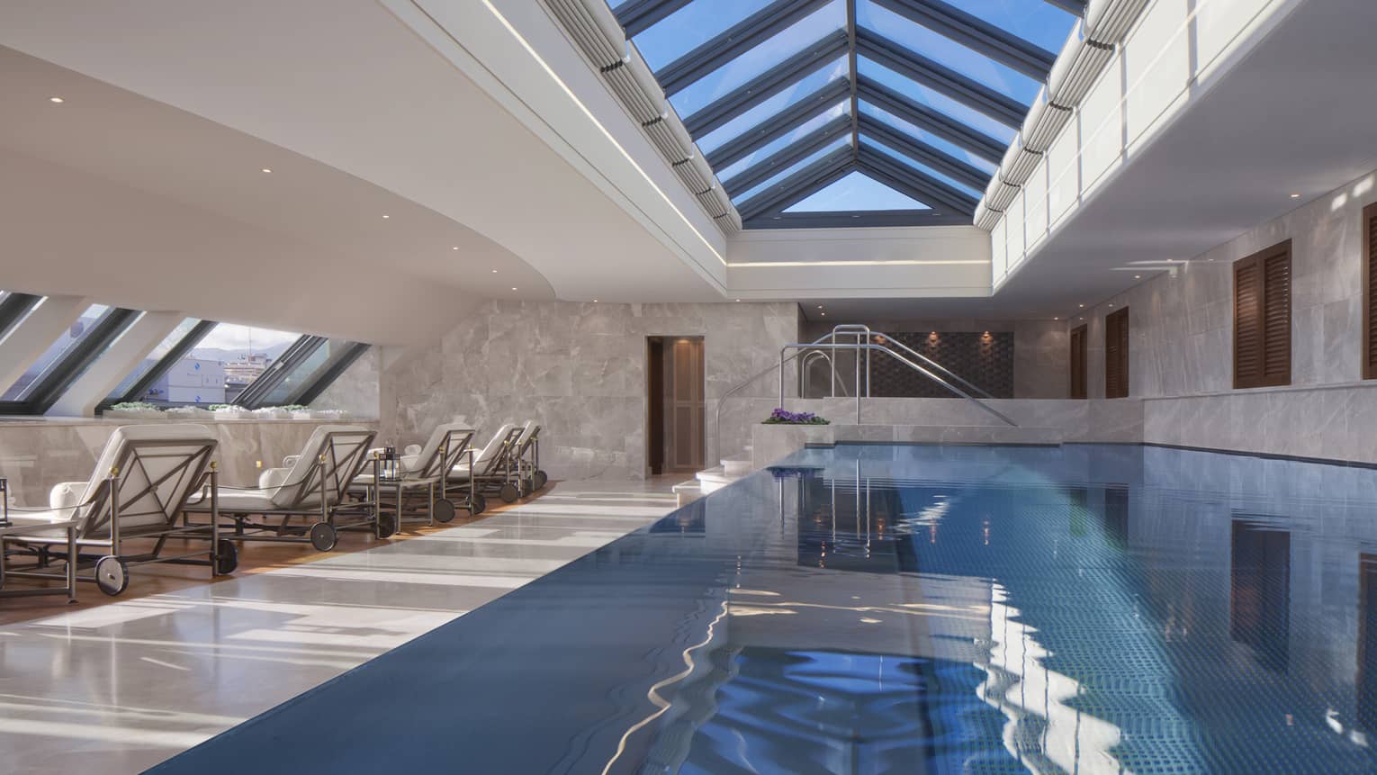 Spa pool under skylights and flanked with lounge chairs