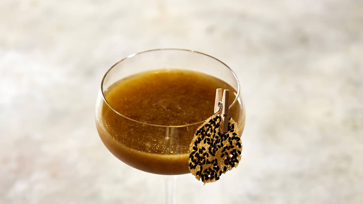 A lone chocolate martini sitting on a marble countertop. 