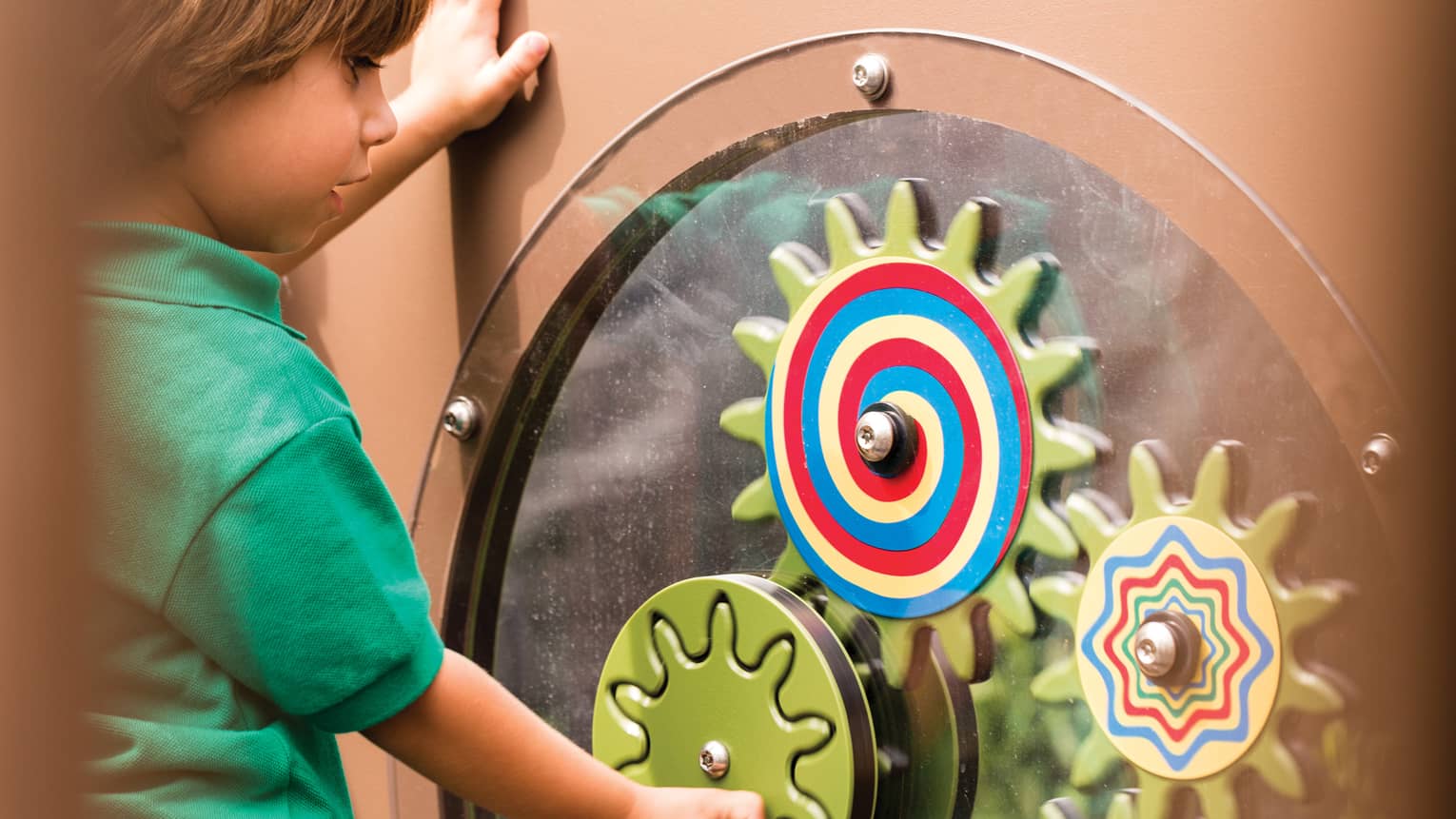 Young boy spins colourful wheel in Discovery Children's Museum