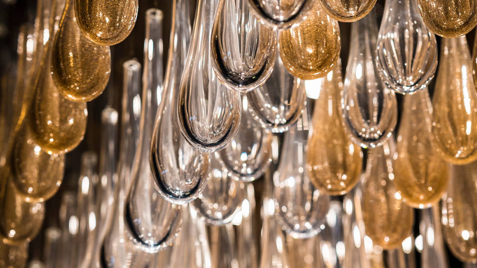 Close-up and clear and gold glass teardrop-shaped lights 