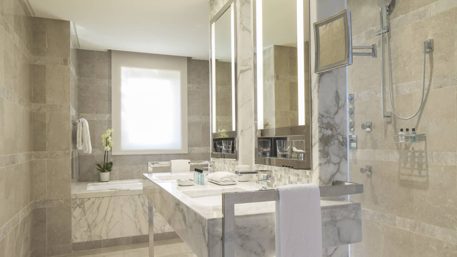 Executive Suite full white and grey marble bathroom, vanity with double sink, tub