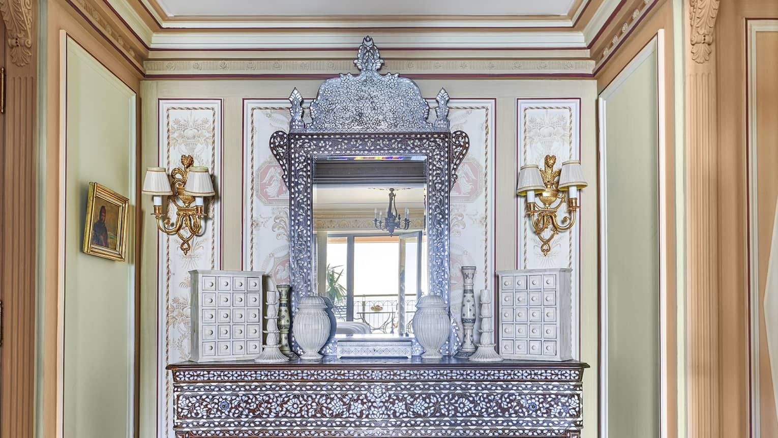 Royal Suite entryway with intricate sideboard, rug and crystal chandelier