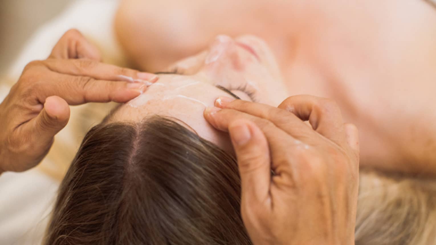 A guest is treated to a calming facial at the spa