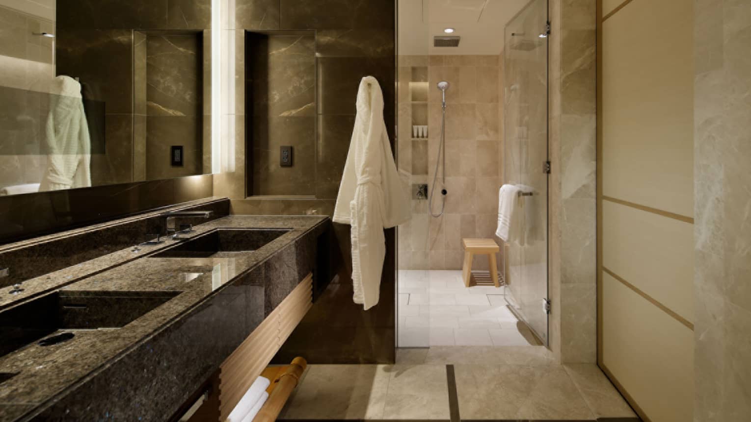 Luxury hotel bathroom with double vanity and walk-in shower