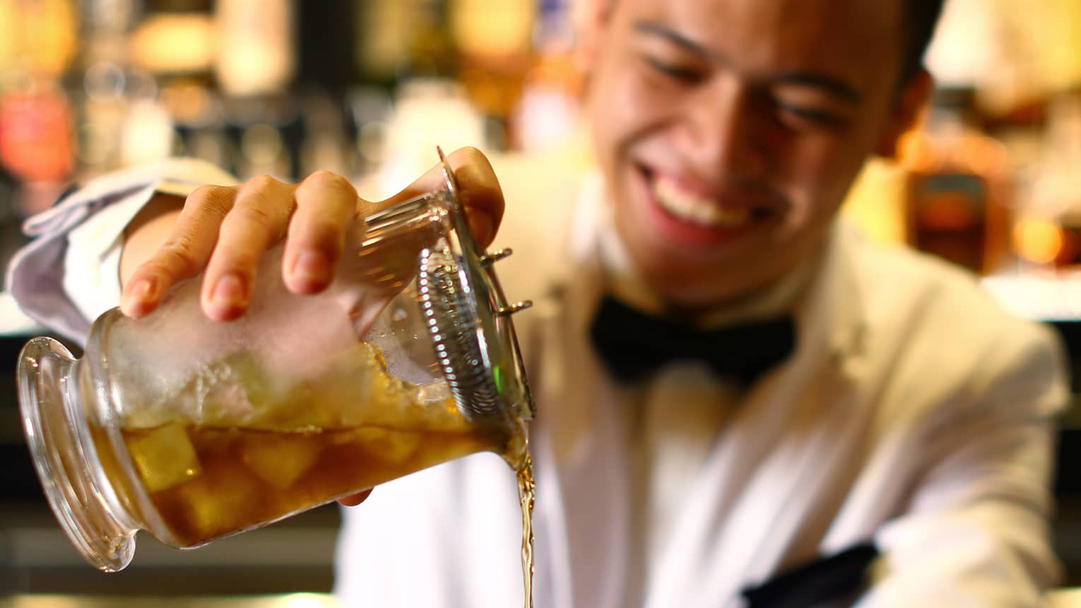 A bartender pours a drink at a Jakarta Hotel bar