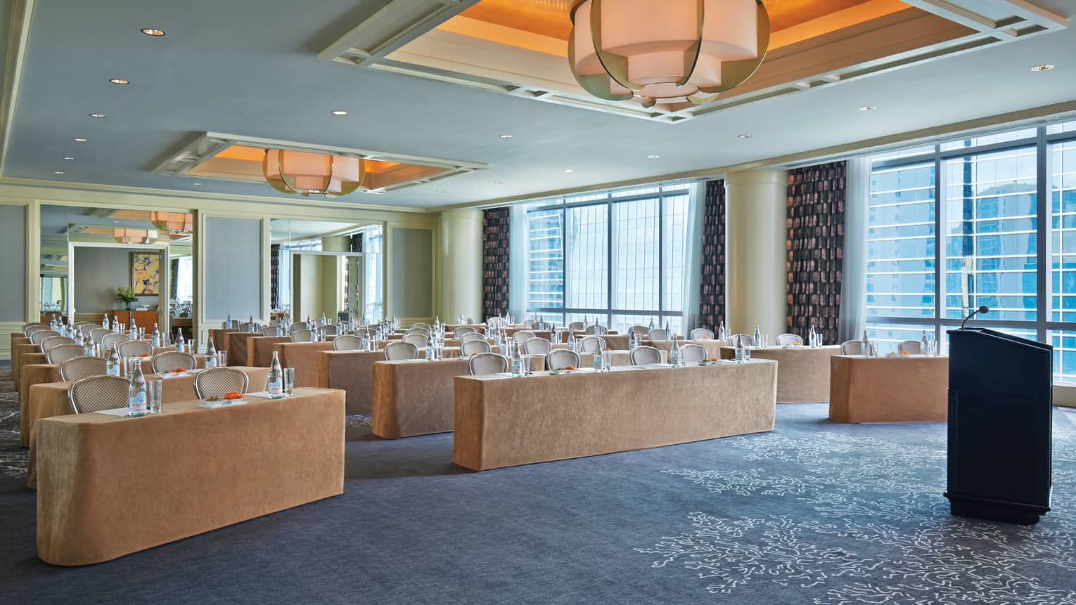 Rows of meeting tables in bright function room