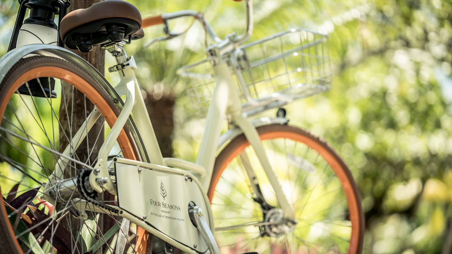 White vintage style bicycle with Four Seasons Hotels logo