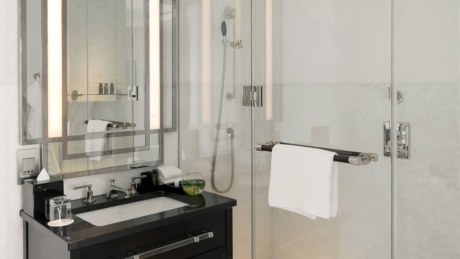 Marble bathroom with dark wood vanity and walk-in shower