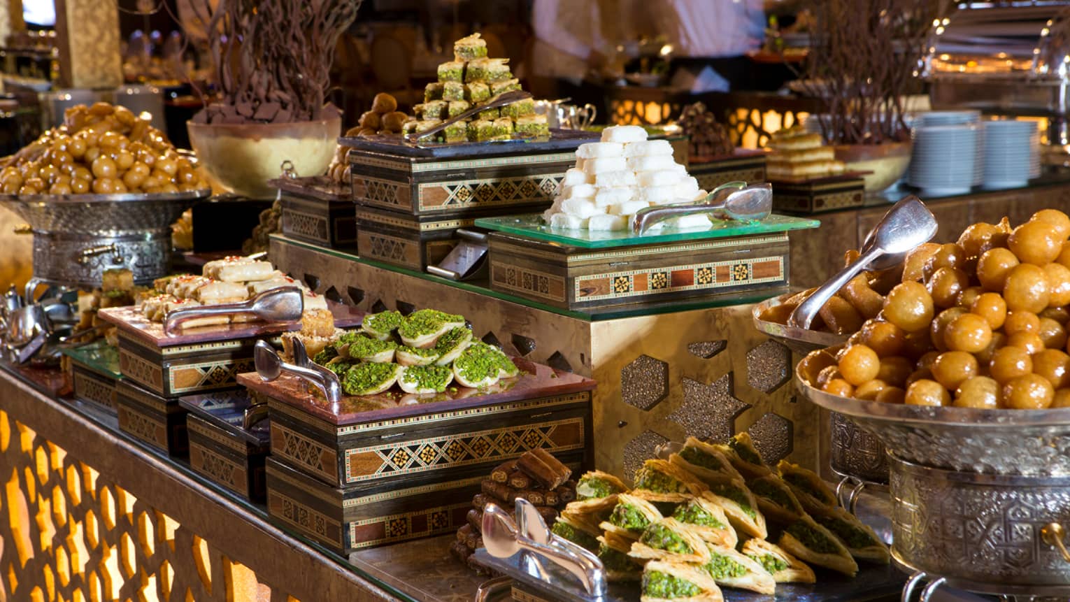 Middle Eastern meze small plates, pastries and sweets on platters on decorative brunch buffet display