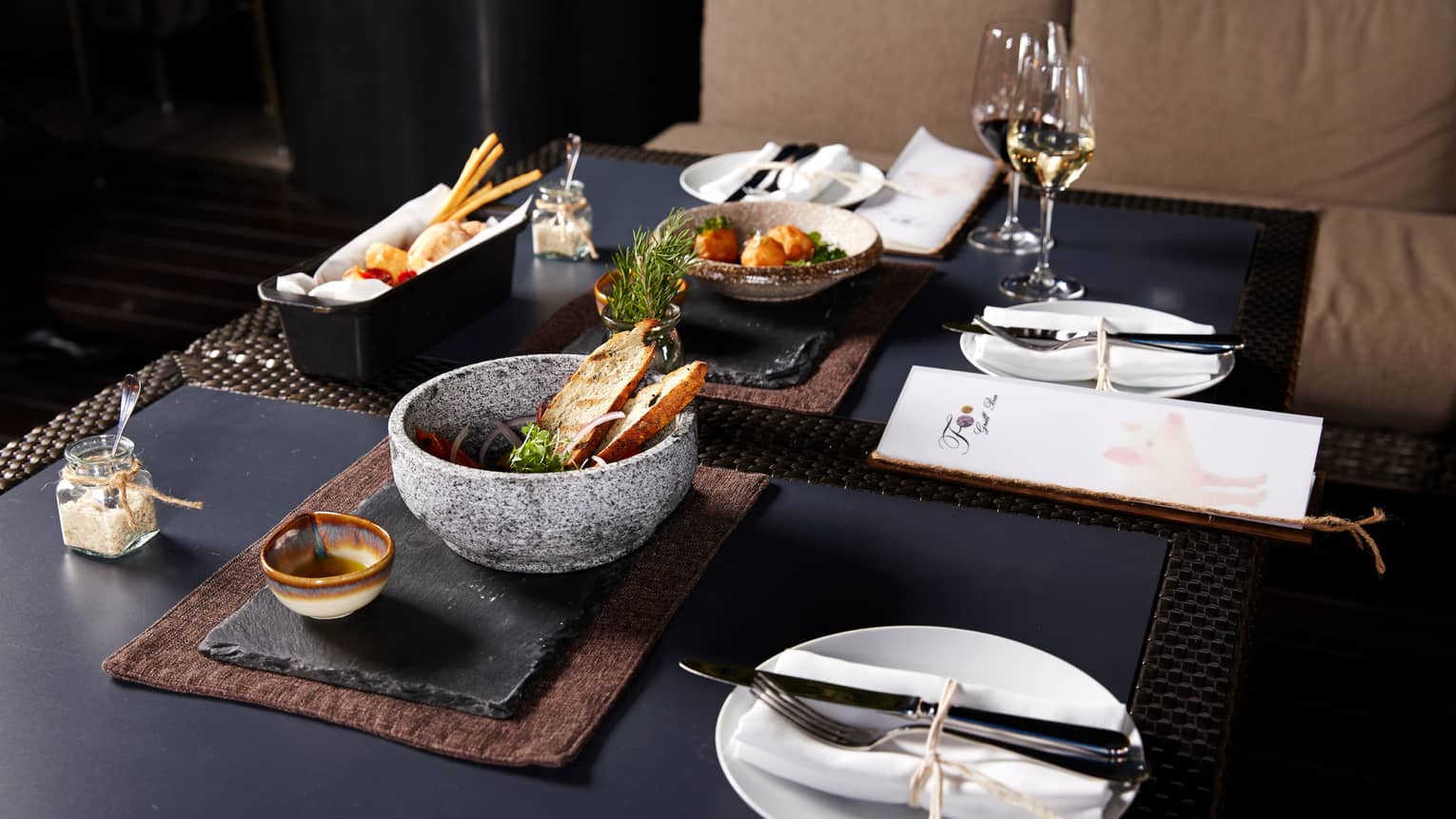 Foo dining table slate platters, bowls with toasts, appetizers