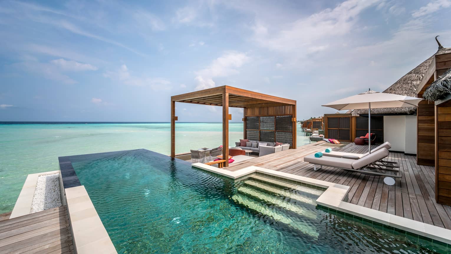 The two-bedroom water suite's extended deck with private pool and shaded lounge area