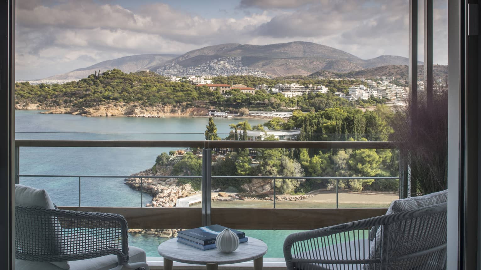 Four Seasons Astir Palace Hotel Athens balcony chairs, table with books, overlooking sea, trees, mountains