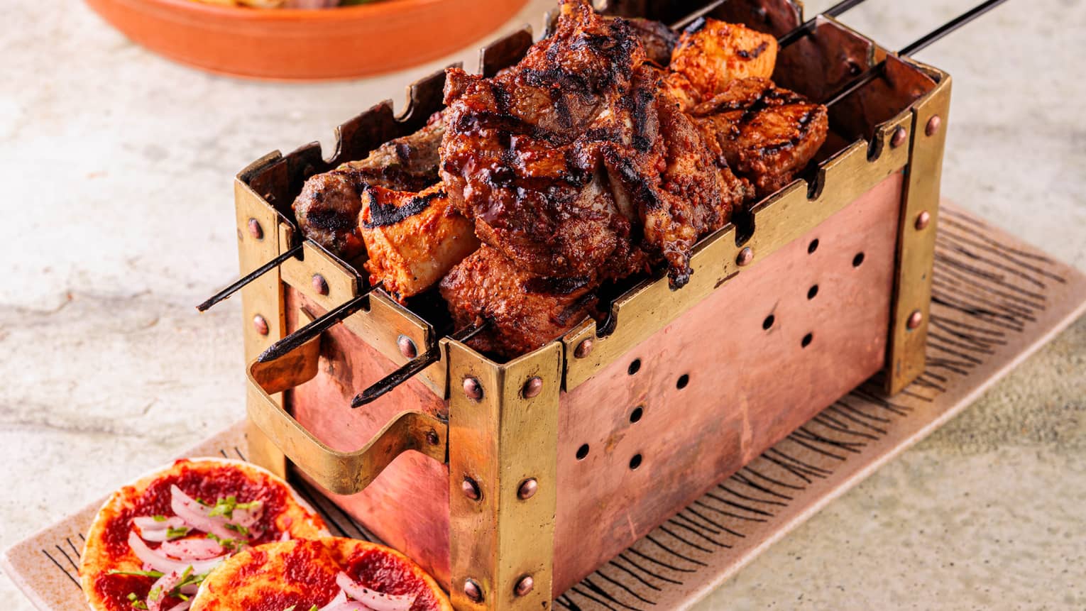 Grilled meats on a tray.